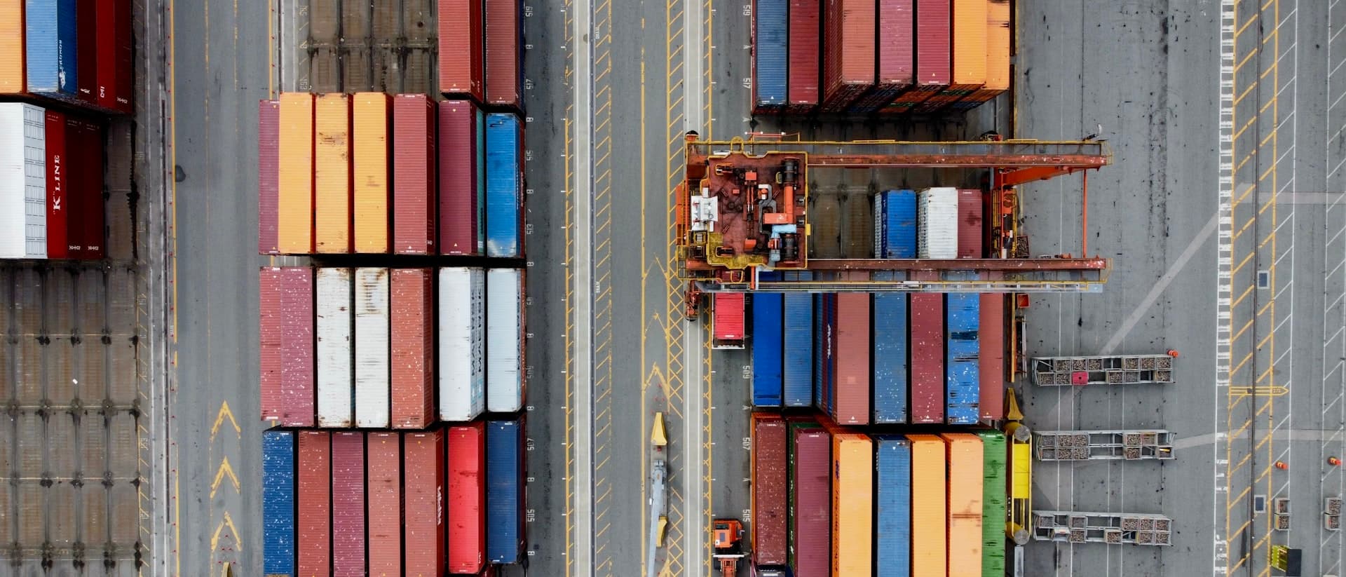 Aerial view of stacked shipping containers at a port terminal